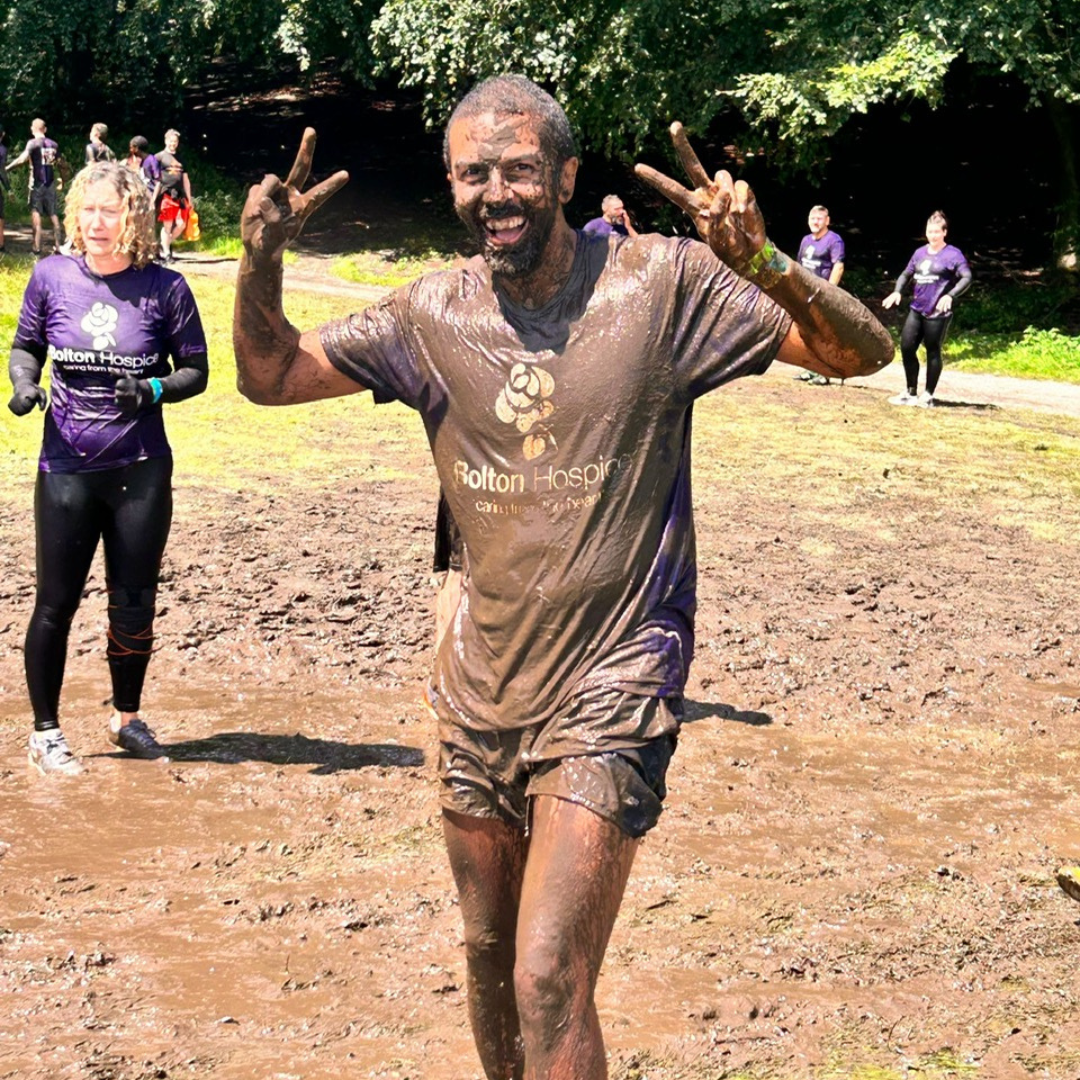 Member of Louisa's Barmy Army covered in mud