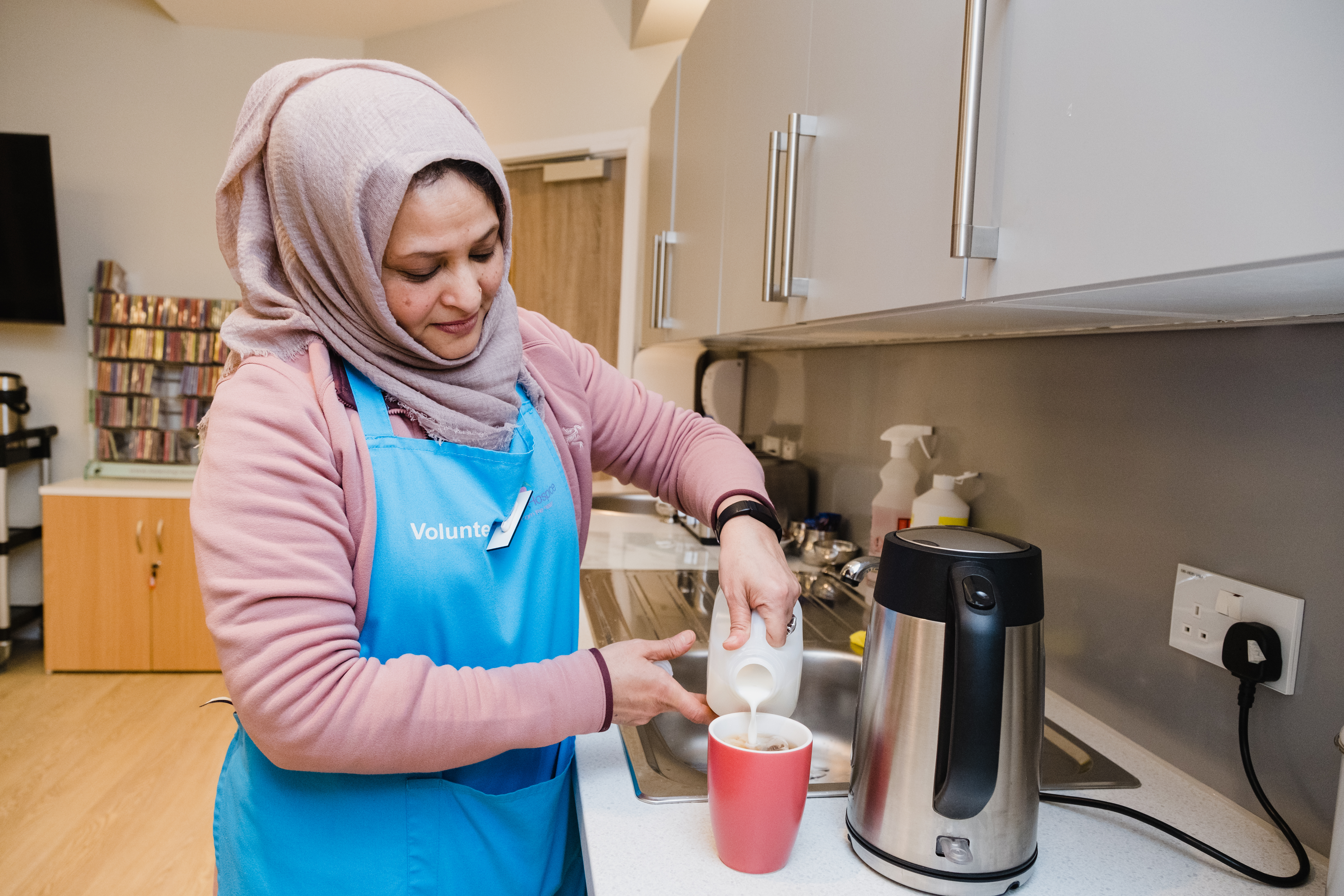 volunteer making cup of tea at wellbeing hub