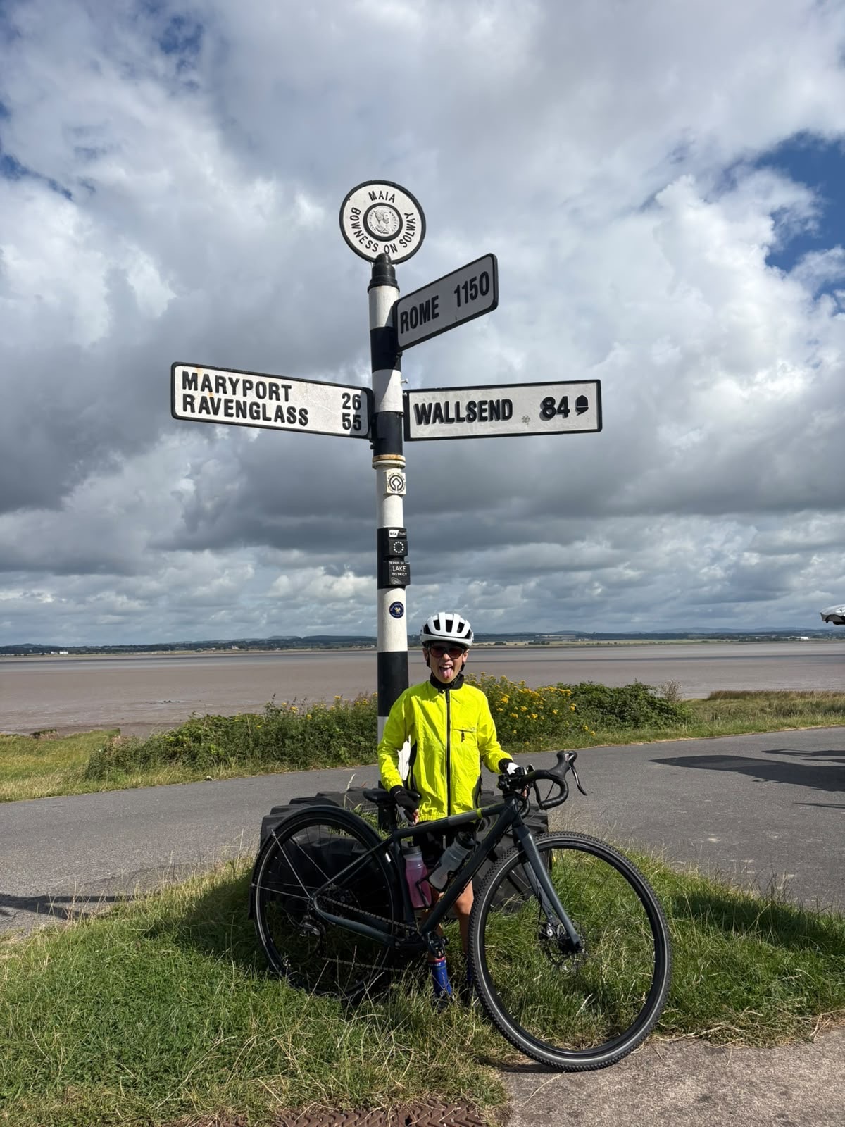 jack stood next to sign at john o groats