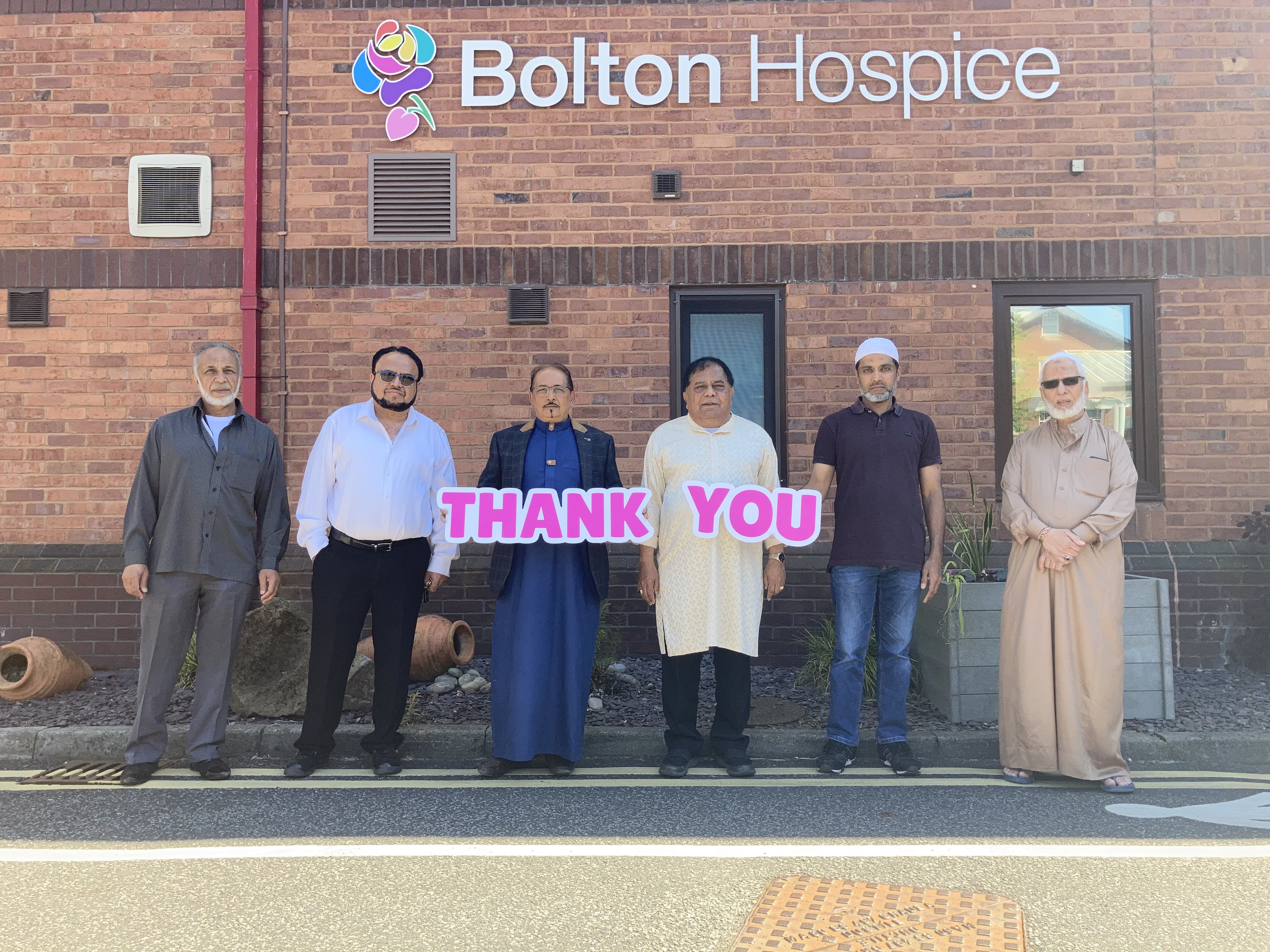 Image of mosque representatives outside Bolton Hospice