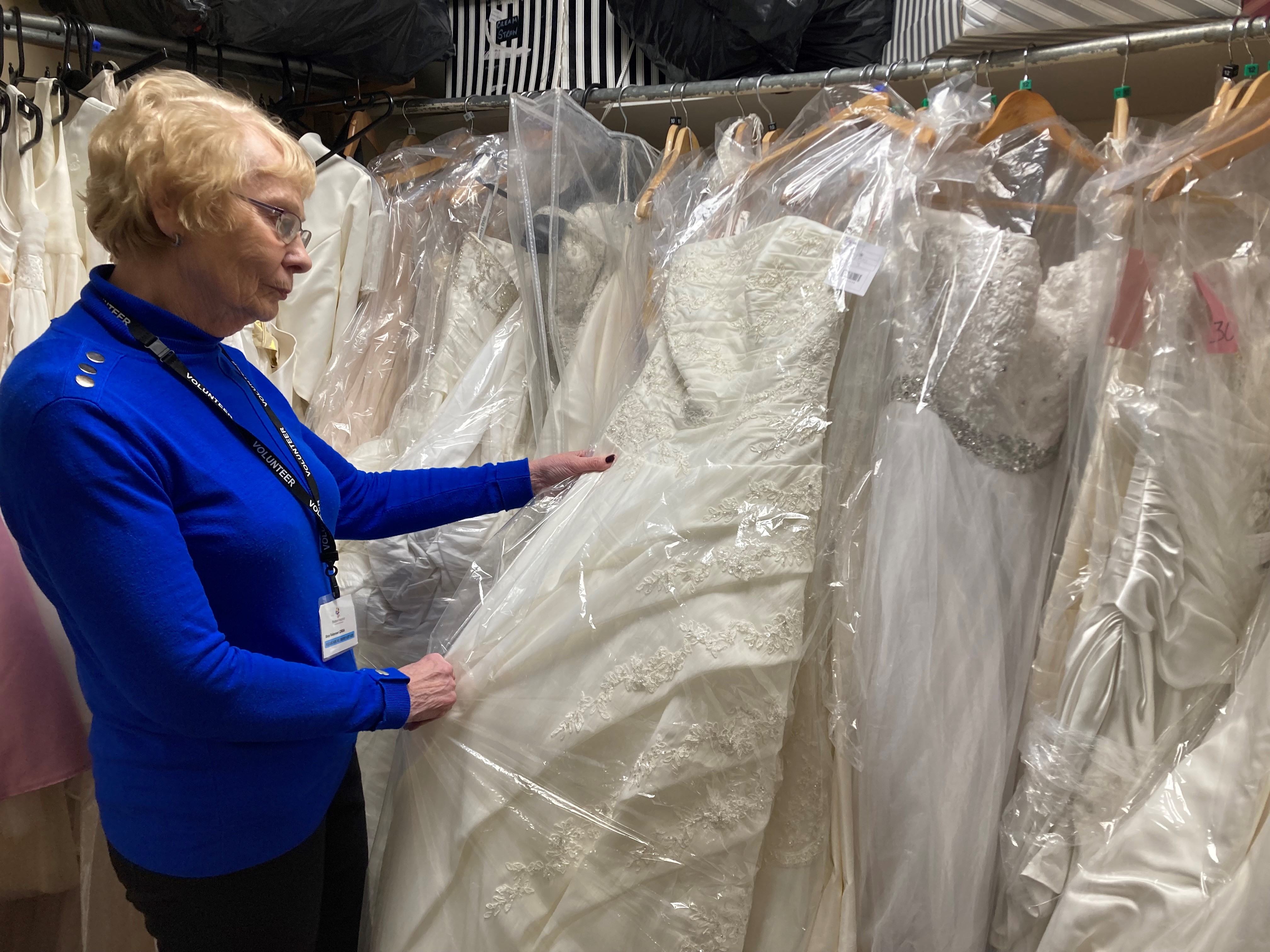 Lynn Piper volunteer with some of the dresses at our Horwich bridal room