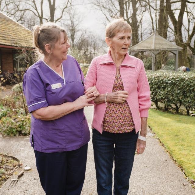 nurse and patient walking in garden