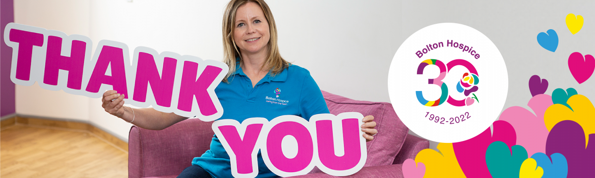 Bolton Hospice staff member with 'thank you' sign